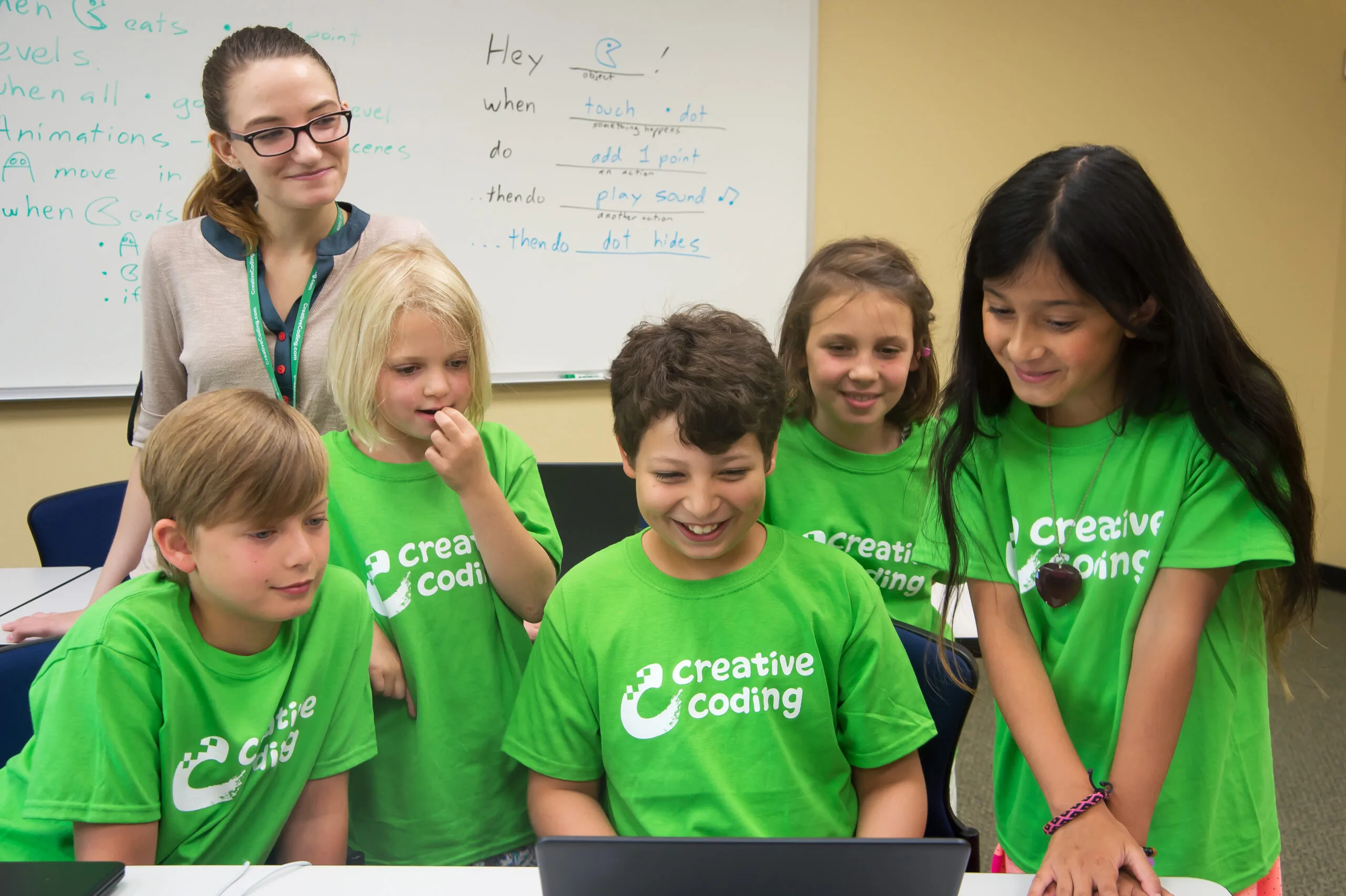 Image of students enjoying coding their own games in our after school program!